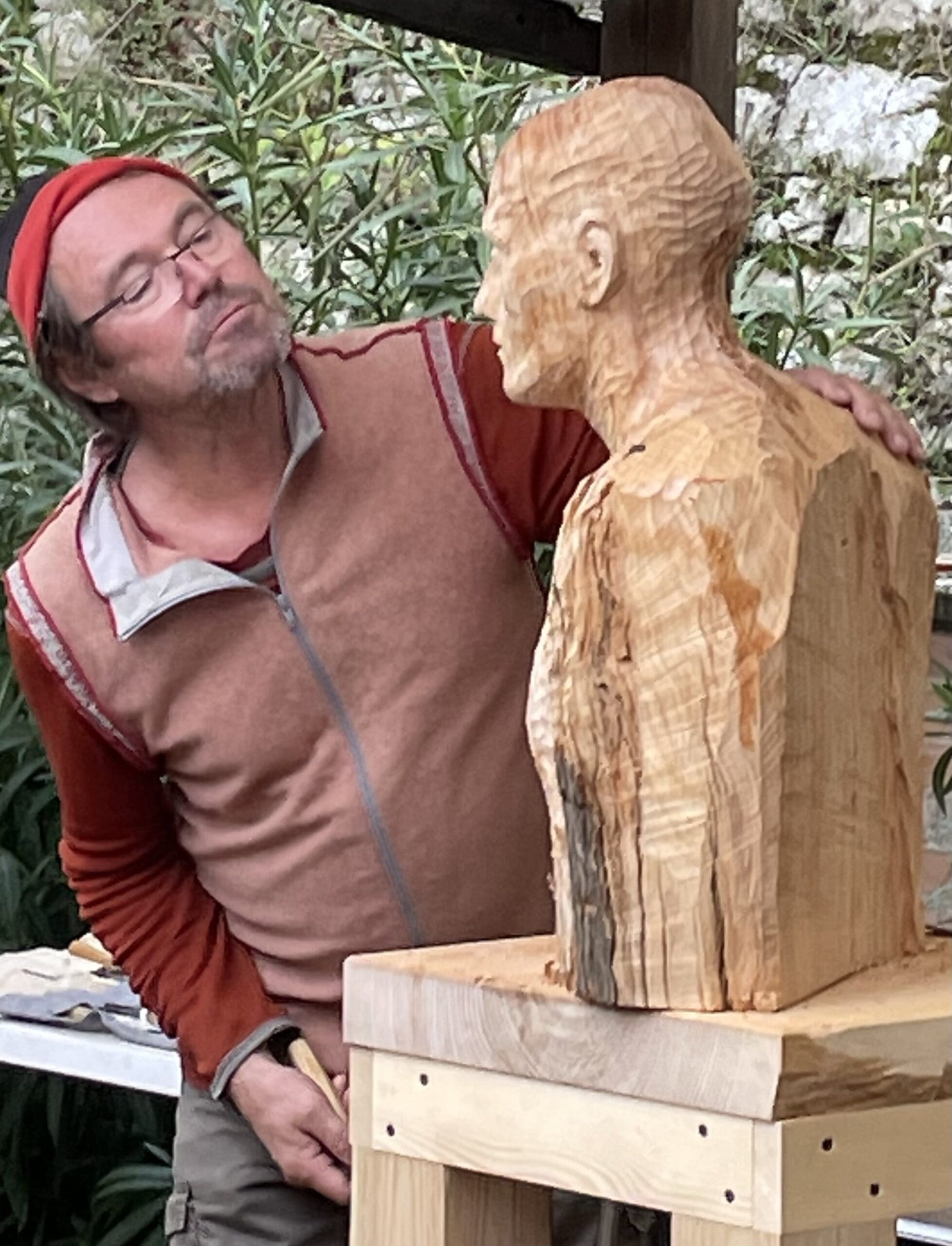 a man admiring his sculpture